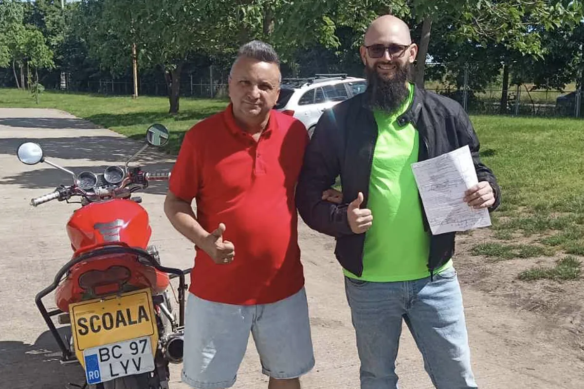 Liviu, instructorul școlii, alături de un cursant care tocmai a promovat examenul moto